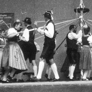 Traditional folk dancers performing on stage.