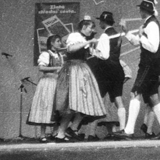 Traditional folk dancers performing on stage.