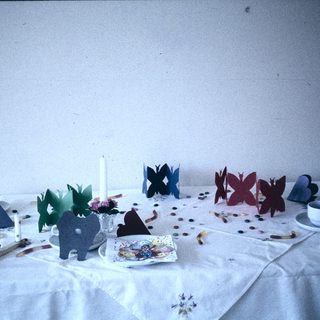 Children's craft table with paper animals and decorations.