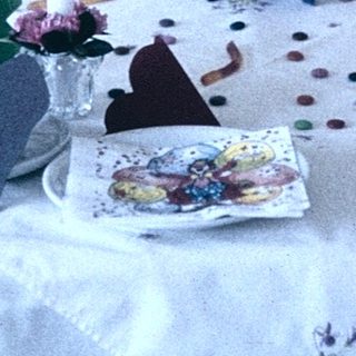 Children's craft table with paper animals and decorations.