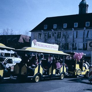 Vintage street festival with yellow "Frühlingsexpress" ride.