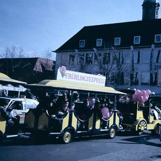 Vintage street festival with yellow "Frühlingsexpress" ride.