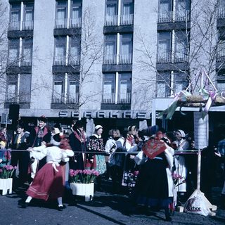 Traditional folk dancers in colorful costumes performing outdoors.