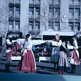 Traditional folk dancers performing outdoors in cultural attire.