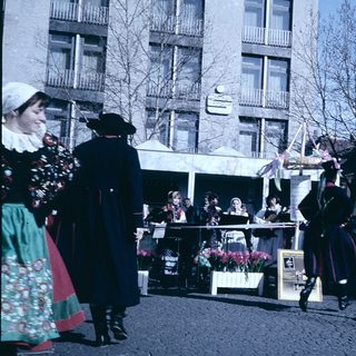 Traditional folk festival with dancers and spectators.