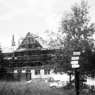 Building under roofing construction with scaffolding.