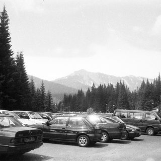 Mountain parking lot with parked cars.