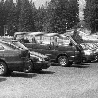 Mountain parking lot with parked cars.