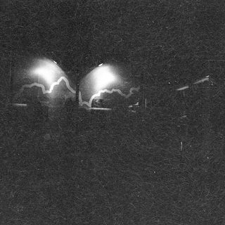 Two glowing eyes in dark surroundings.