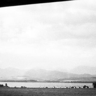 Scenic lake view with distant mountains.