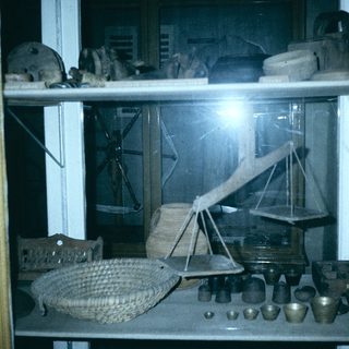Vintage tools and household items in display case.