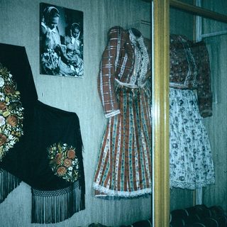 Traditional folk costumes and embroidered accessories displayed.