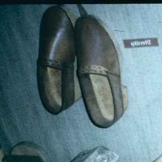 Traditional footwear and shoemaking tools on display.