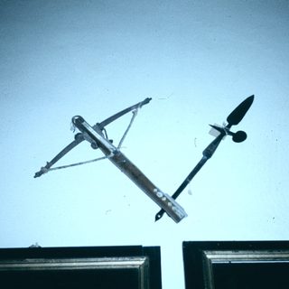 Wind vane and anemometer mounted on roof.