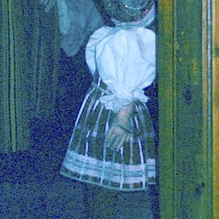 Historical figures in traditional 19th-century attire indoors.
