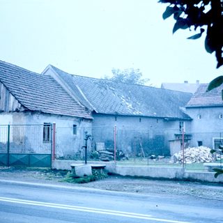 Rural buildings with aged, weathered exteriors.