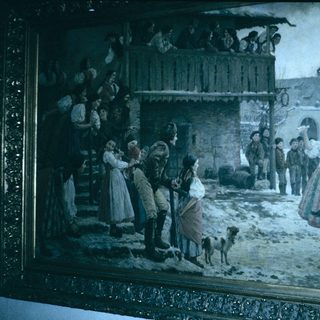 Winter village street scene with festive gathering.