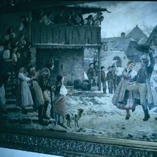 Winter village street scene with festive gathering.