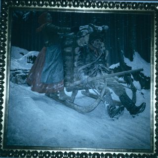 Winter scene of sledding through snowy forest.