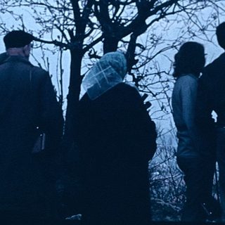 Group of people sightseeing at scenic viewpoint.