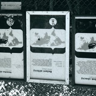 Informational zoo signs about animal habitats and origins.