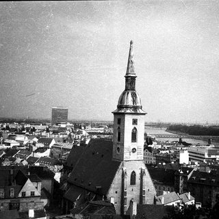 Historic cityscape featuring prominent church tower.