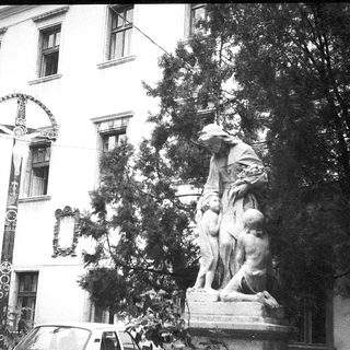 Statue group in front of historic building.