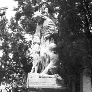 Statue group in front of historic building.