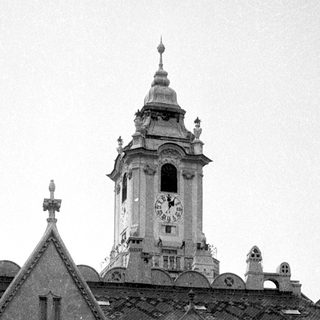 Historic building with "Muzeum" sign and clock tower.