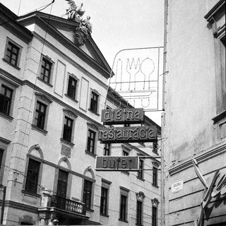 Historic building with vintage restaurant sign "Dieva Restauracija Ruter".