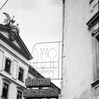 Historic building with vintage restaurant sign "Dieva Restauracija Ruter".