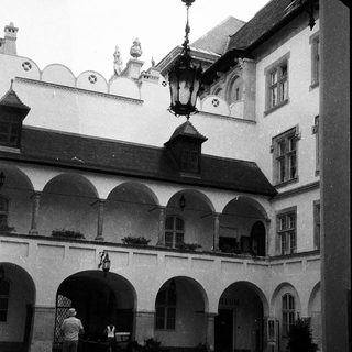 Historic courtyard with arched colonnade and lantern.