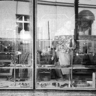 Vintage storefront display with household items.