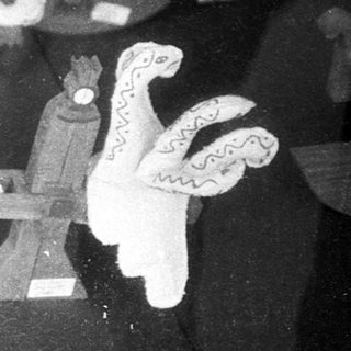 Toy figures arranged on a reflective surface.