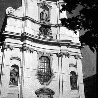 Baroque-style church facade with coats of arms.