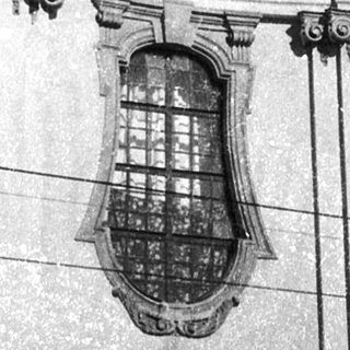 Baroque-style church facade with coats of arms.