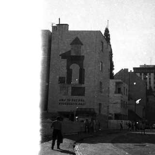 Historic urban street scene with old building and signage.