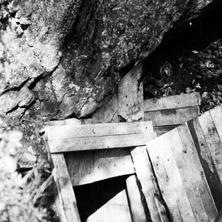 Rough wooden entrance to underground mine shaft.