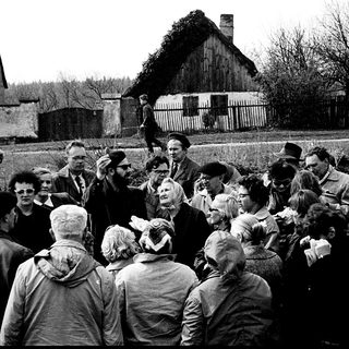 Group of people gathered outdoors during a public speech or event.