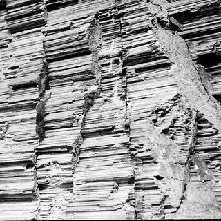 Layered sedimentary rock with visible erosion patterns.