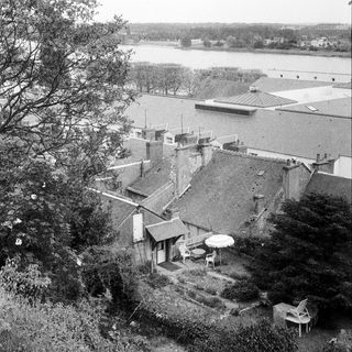 Aerial view of rural buildings and roadside structures.