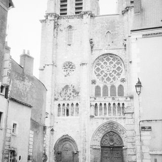 Gothic cathedral facade with rose window and flying buttresses.