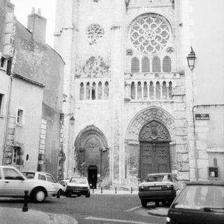 Gothic cathedral facade with rose window and flying buttresses.