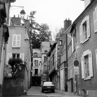 Narrow alleyway between residential buildings.