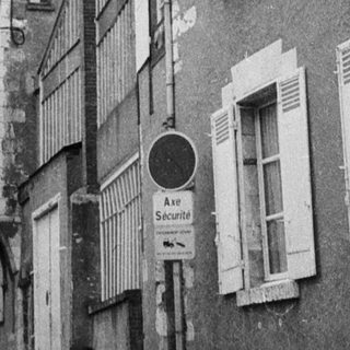 Narrow alleyway between residential buildings.