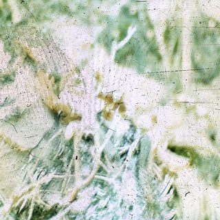 Blurred abstract texture of greenish fabric.