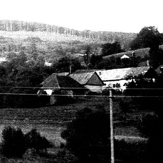 Rural landscape with scattered houses and fields.