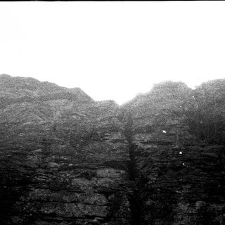Misty cliffs with jagged rock formations.