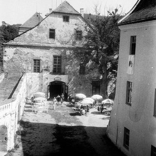 Historic stone castle courtyard with outdoor seating.