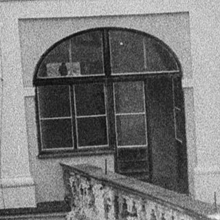 Historic building with arched passageways and courtyard.